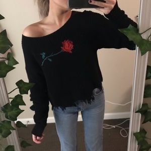 Embroidered and distressed sweater